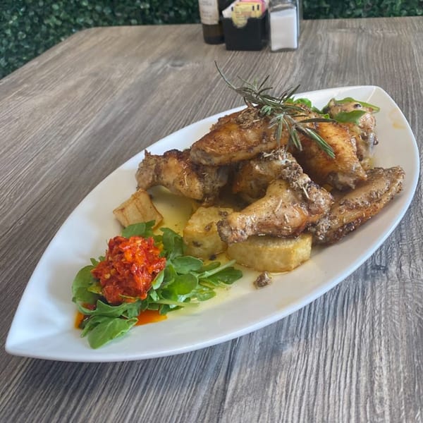 Cibo by Illiano's Italian chicken wings with rosemary, potatoes, and red pepper relish.