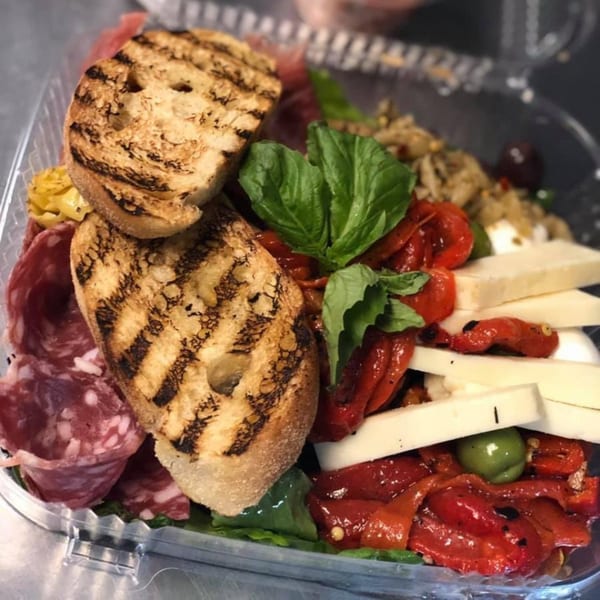 Cibo by Illiano's Italian antipasto with grilled bread, salami, roasted peppers, cheese, and basil.