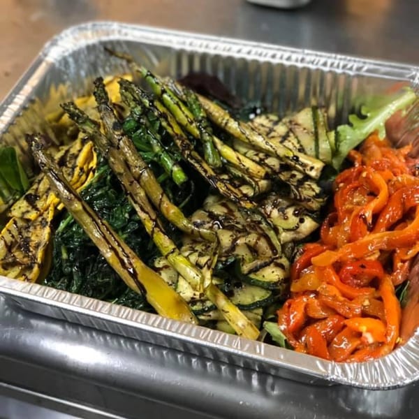 Cibo by Illiano's catering tray with grilled asparagus, zucchini, squash, spinach, and roasted red peppers.