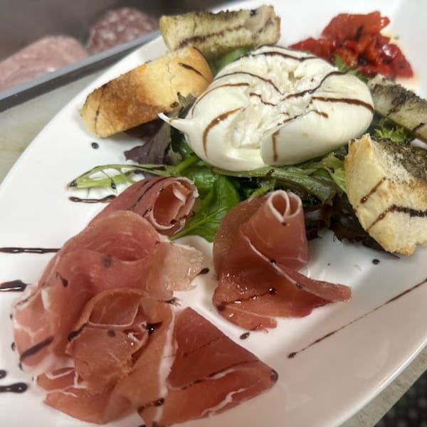 Cibo by Illiano's Italian appetizer with prosciutto, burrata cheese, roasted peppers, and toasted bread.